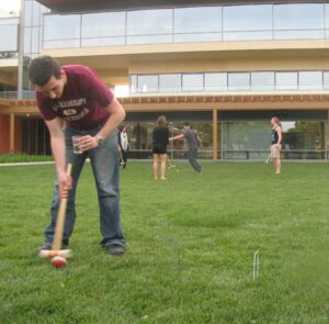 Sam Stone (in foreground) playing croquet. 2012.